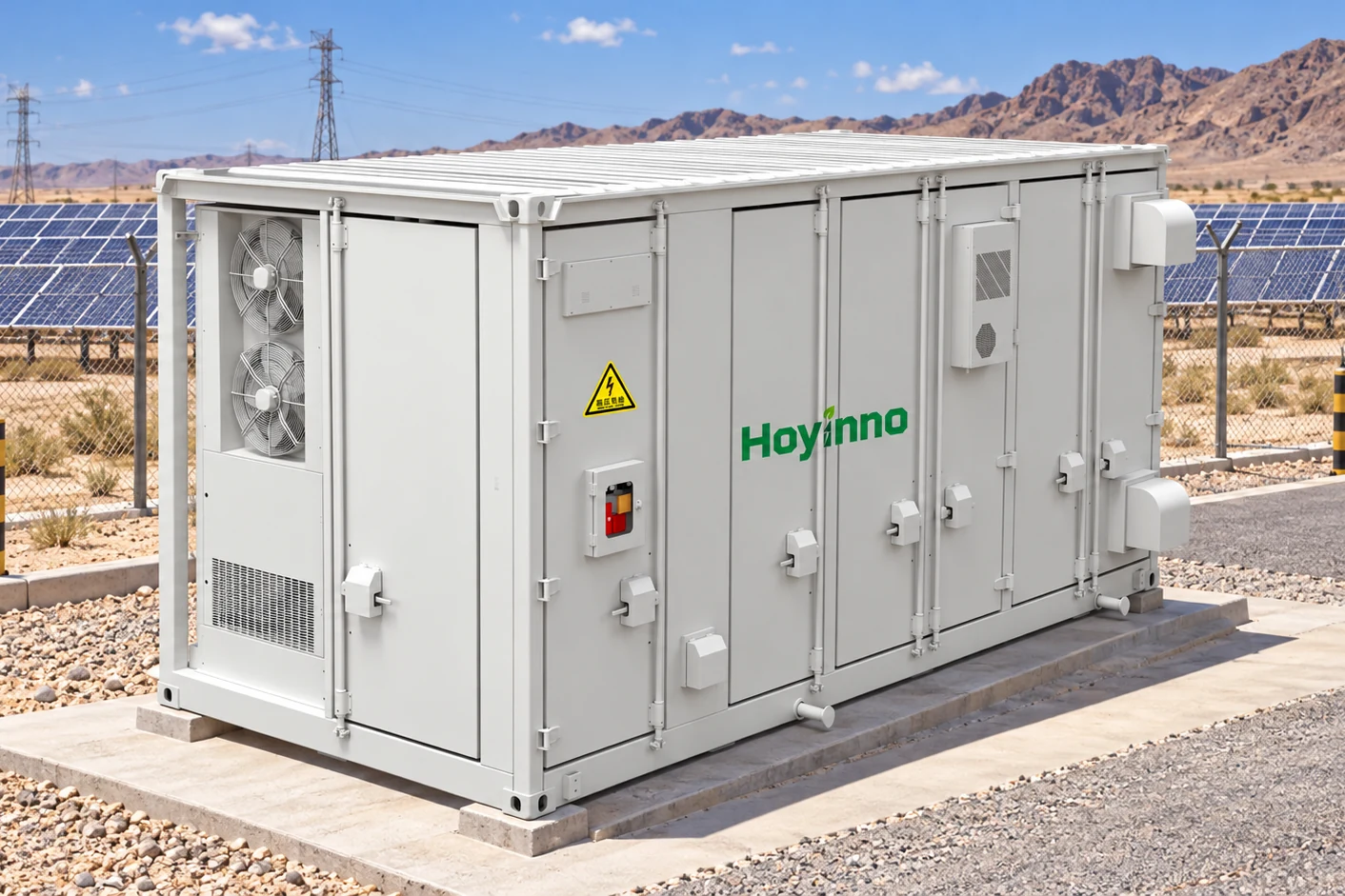 Three-quarter view of a Hoyinno liquid-cooled battery container in a tropical microgrid compound